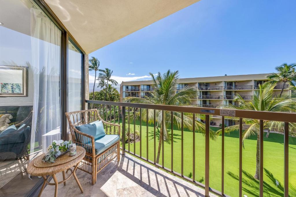 einen Balkon mit einem Stuhl und einem Tisch in der Unterkunft Maui Sunset A404 in Kihei