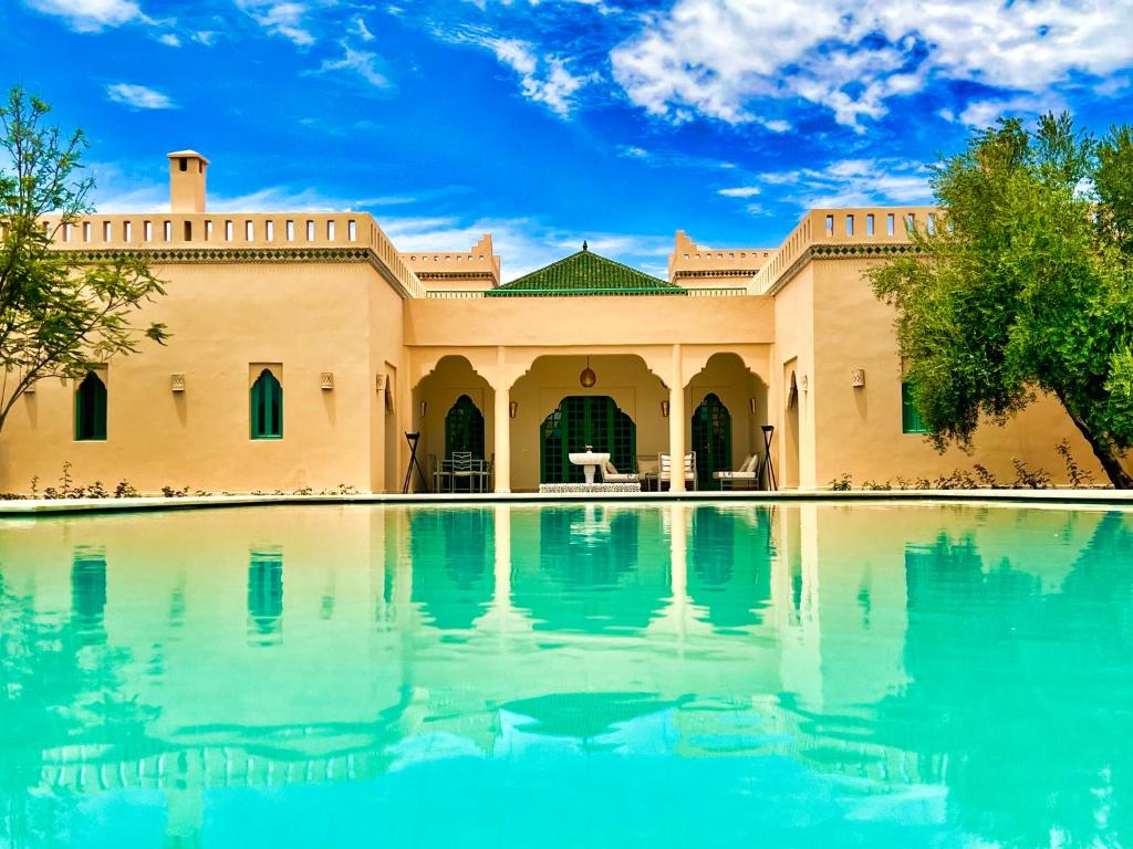 a house with a pool in front of it at Villa Riadi in Marrakech in Marrakech
