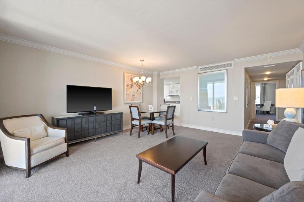 a living room with a couch and a table at Marco Beach Ocean Suites in Marco Island