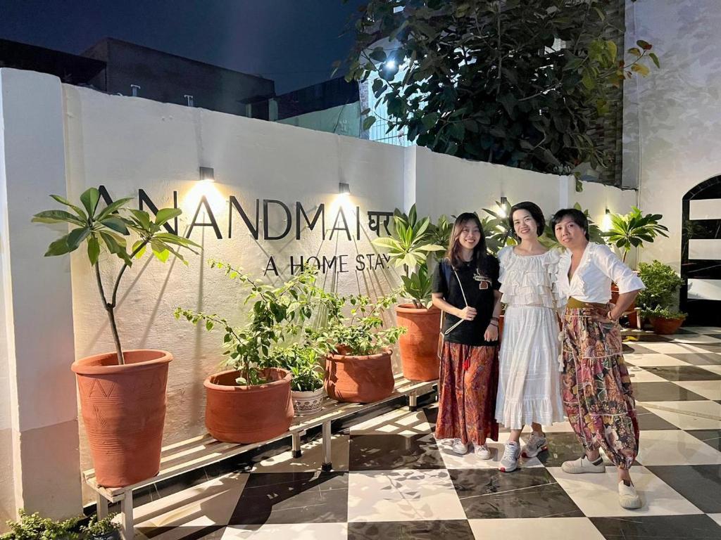 een groep van drie vrouwen die voor planten staan bij AnandMai Ghar - A Homestay in Gwalior in Gwalior