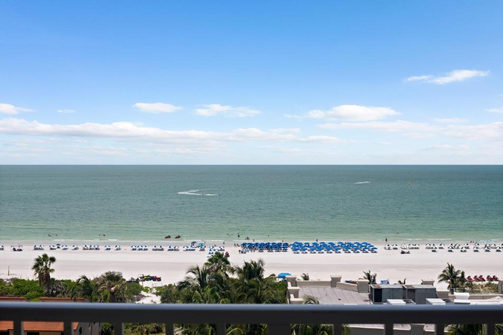 a view of the beach from the balcony of a resort at Marco Beach Ocean Suites in Marco Island