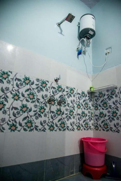 a bathroom with a toilet and a camera on the wall at Little prince guest house & homestay in Bikaner