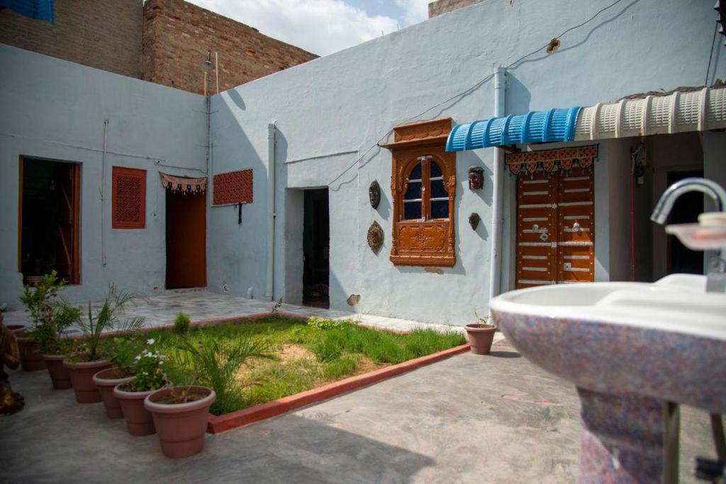 a bathroom with a sink next to a building at Little prince guest house & homestay in Bikaner
