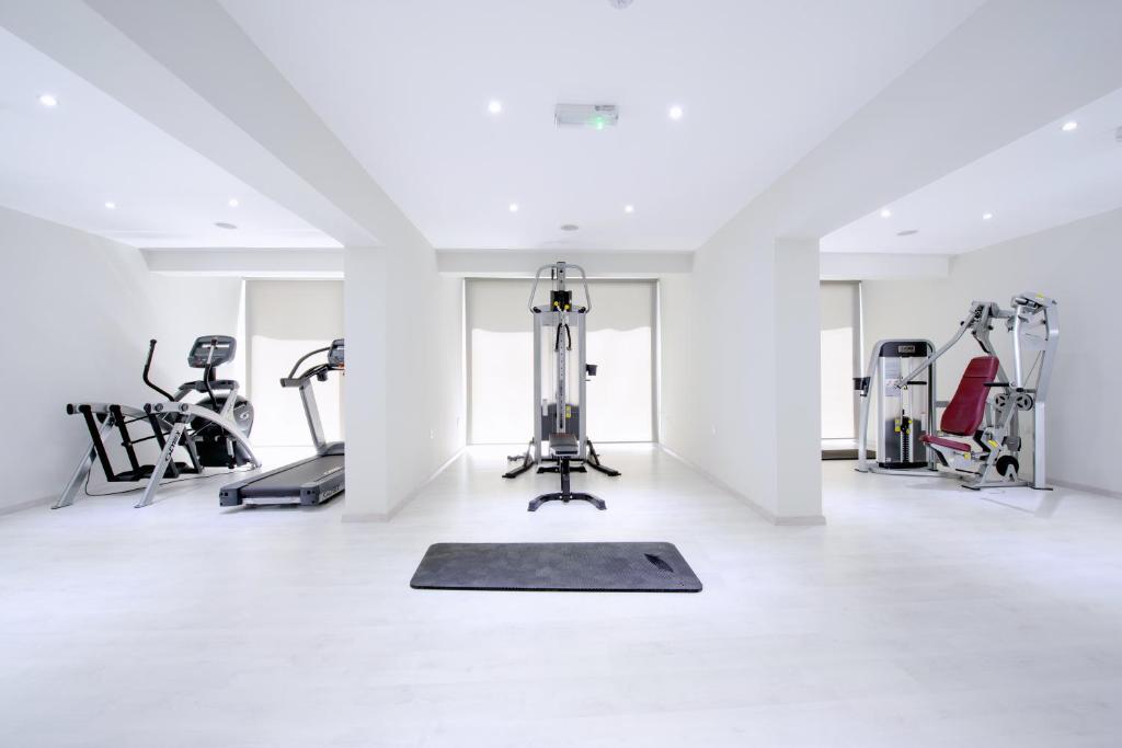 a gym with cardio equipment in a white room at River Rock Hotel in Ayia Napa