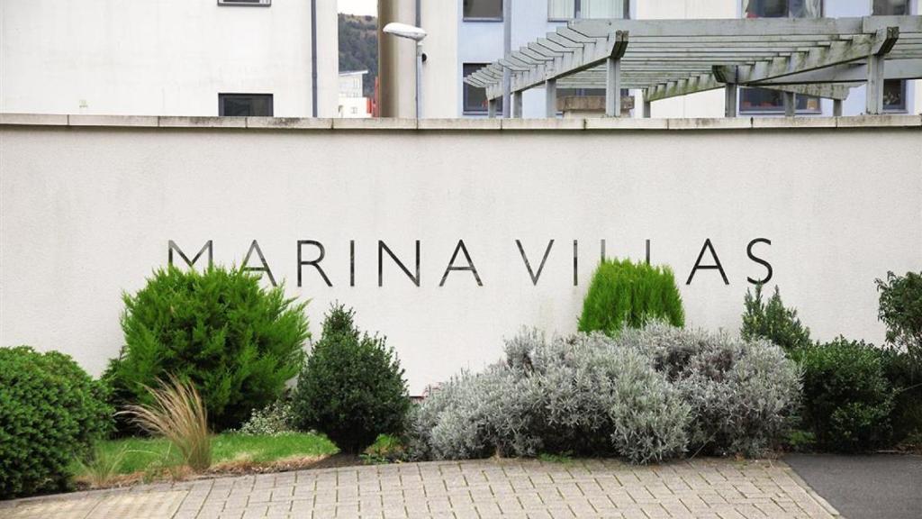 a sign for marina villas on the side of a building at Marina Villas, Trawler Road, Marina in Swansea