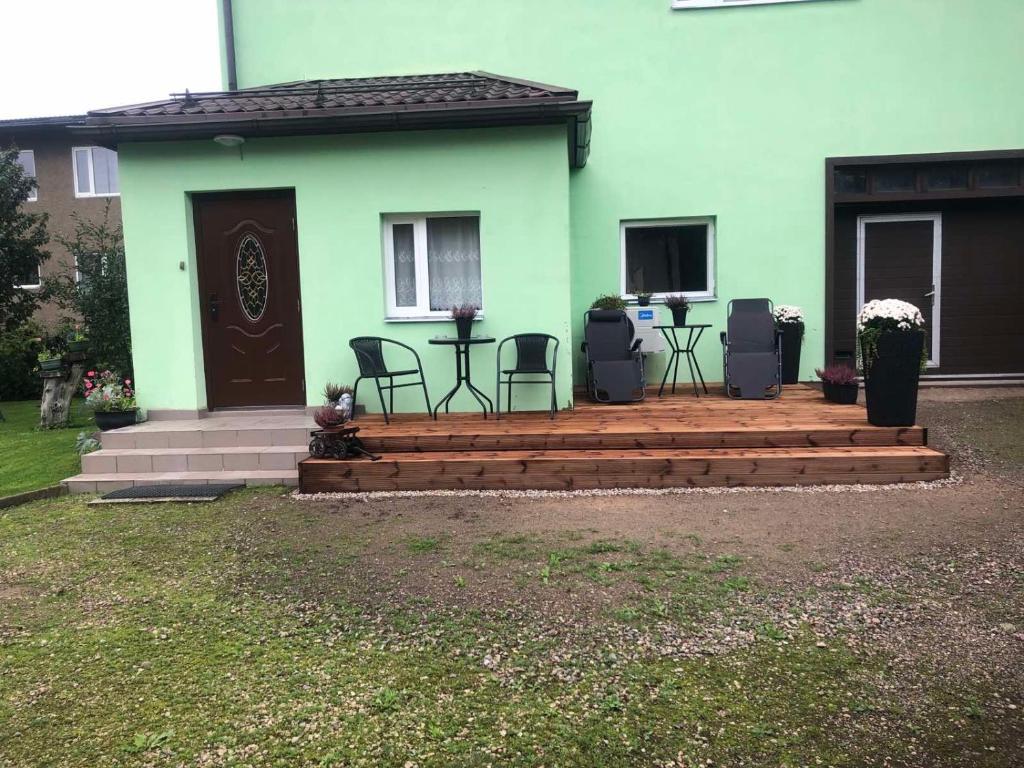 ein Haus mit einer Terrasse mit Stühlen und einer Tür in der Unterkunft Künni majutus in Viljandi