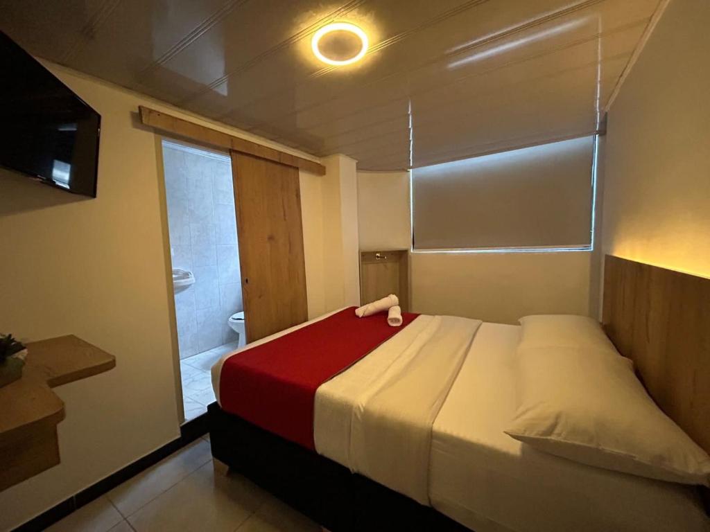 Postel nebo postele na pokoji v ubytování Hotel Urban Center Bogota