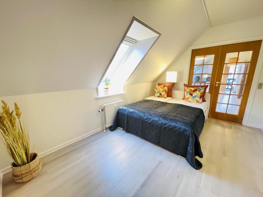 a bedroom with a bed and a window at aday - Great 1 bedroom central apartment in Hjørring