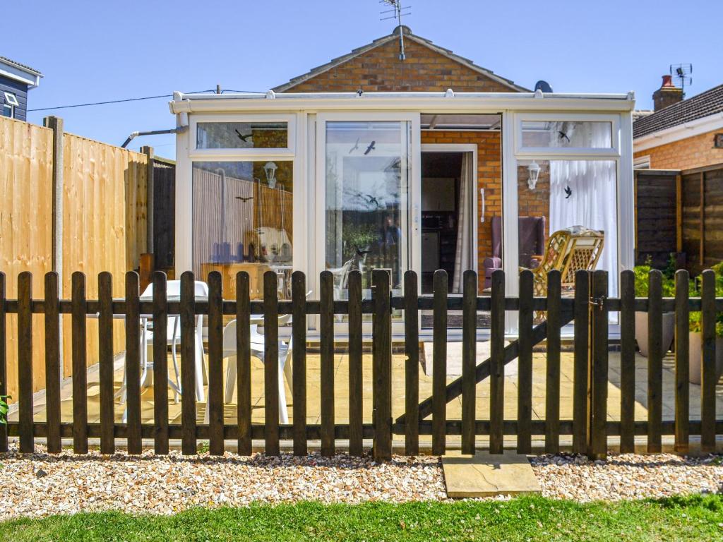 a wooden fence in front of a house at Dovecote Annex in Mablethorpe