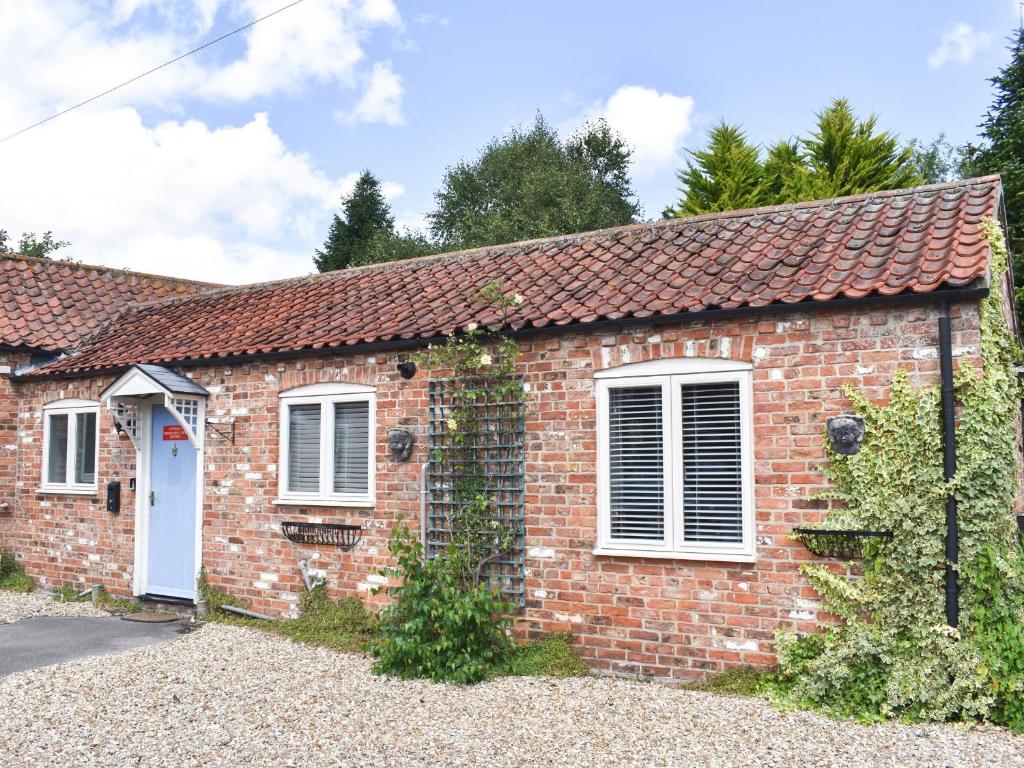 Casa de ladrillo con puerta blanca y ventanas en Church Bell View Cottage - Ukc4276, en Orby