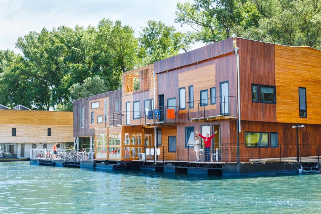 a building on a dock on a body of water at ArkaBarka 2- Floating Dream Rooms and Apartments in Belgrade