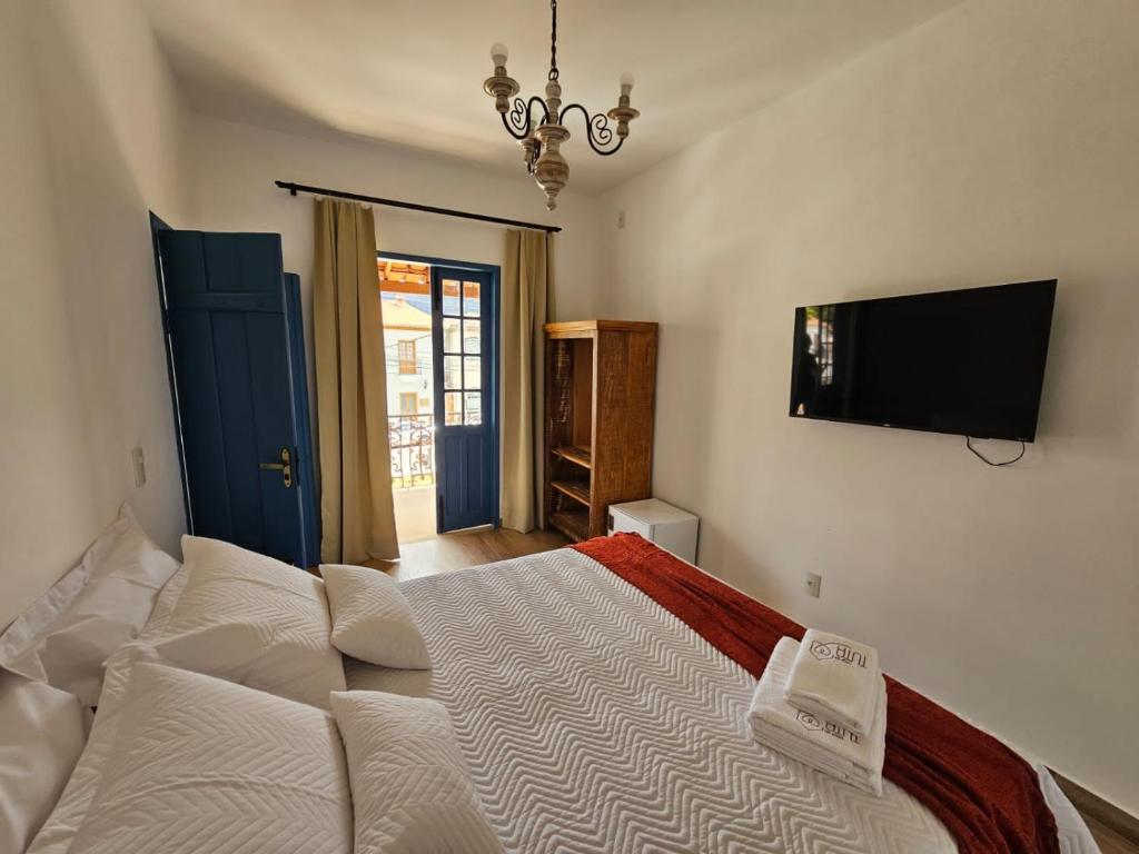 Кровать или кровати в номере Casa da Tuta Pousada