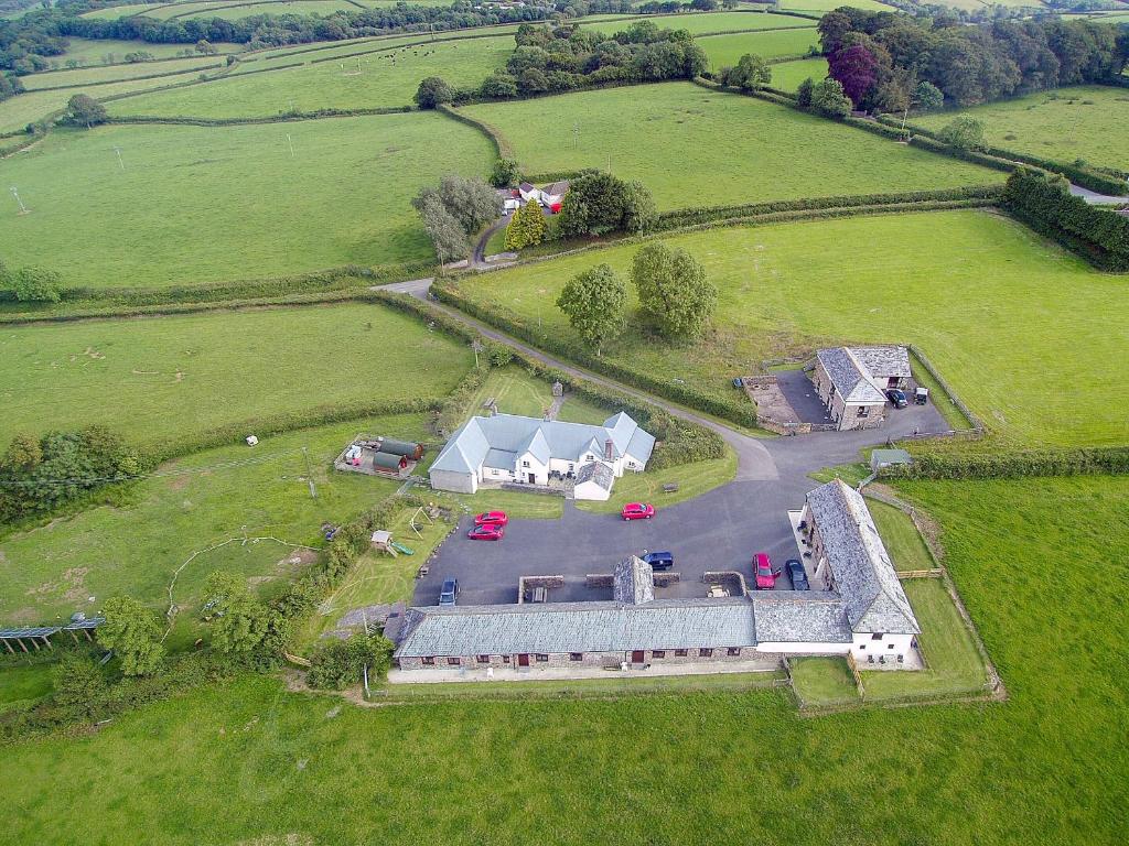 an aerial view of a large house in a field at Well Farm Cottage - Uk11879 in North Tamerton