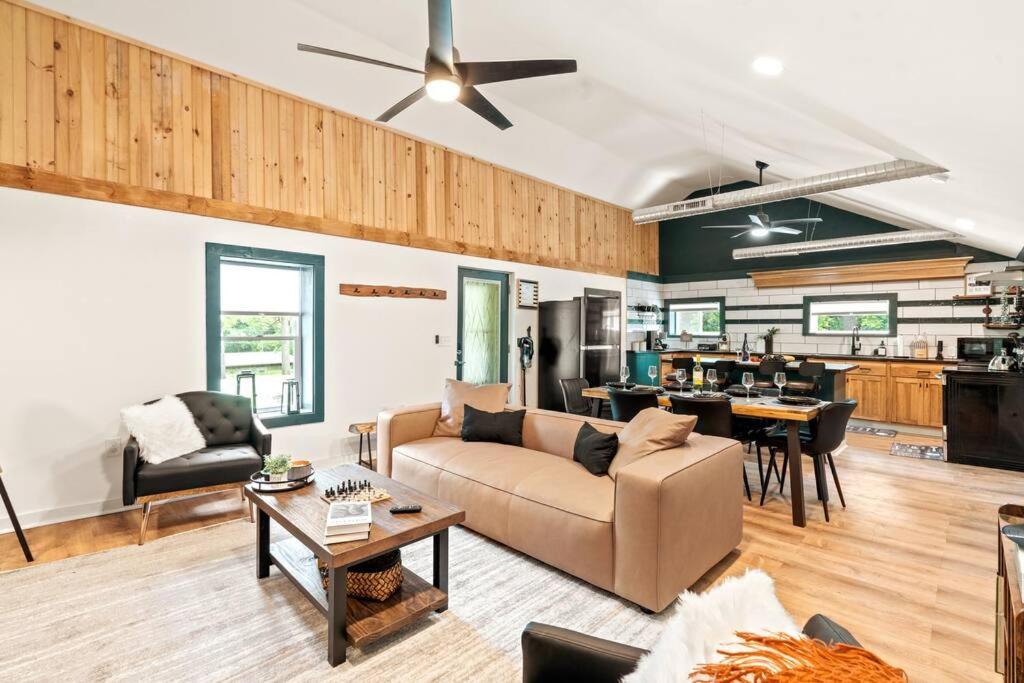 ein Wohnzimmer mit einem Sofa und einem Tisch in der Unterkunft The Modern Forge @ Honeoye Lake in Honeoye