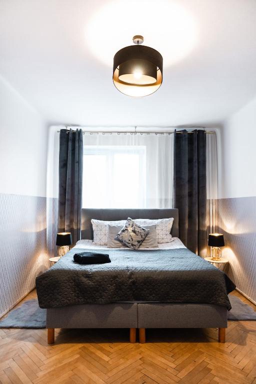 a bedroom with a bed with a large window at ClickTheFlat Wilcza 35 City Center Apart Rooms in Warsaw