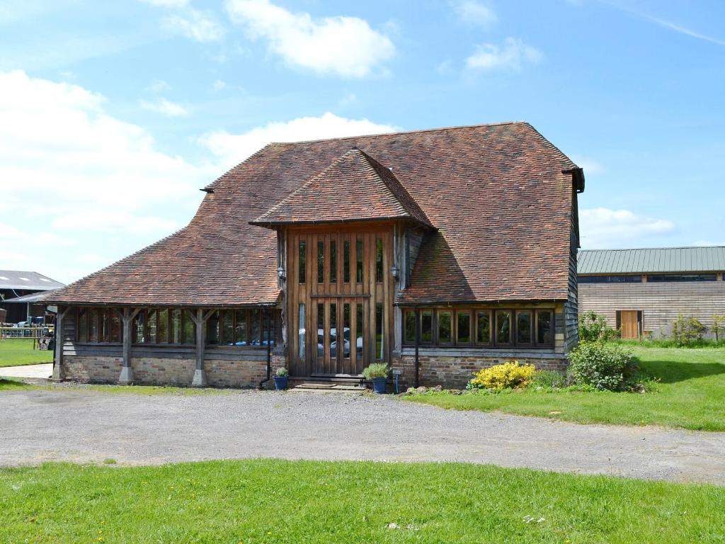 a large building with a brown roof at Romden Barn in Smarden