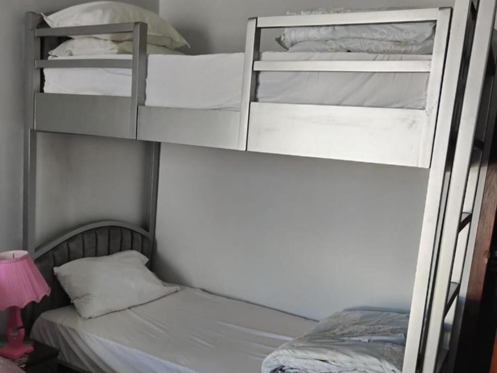 two bunk beds in a room with a bed at Porto Said in Port Said