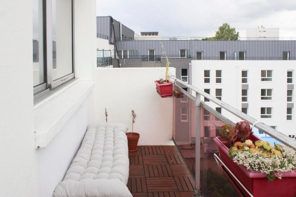 an apartment balcony with white walls and white furniture at 47 m2 bright nest near Paris in Aubervilliers