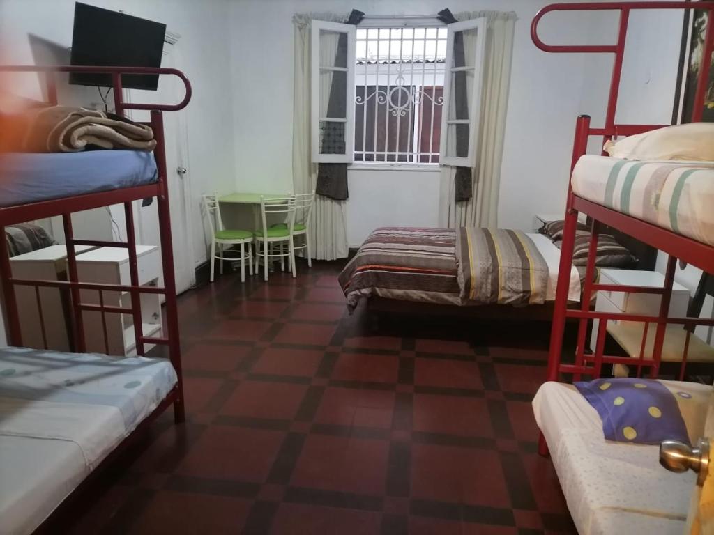 a room with bunk beds and a checkerboard floor at EL SEÑORIAL in Lima