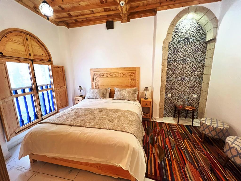 Postel nebo postele na pokoji v ubytování Riad Al Manara
