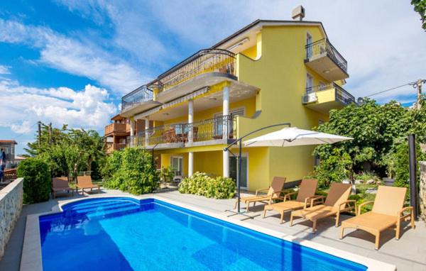 a house with a swimming pool next to a building at Apartment MARO in Senj