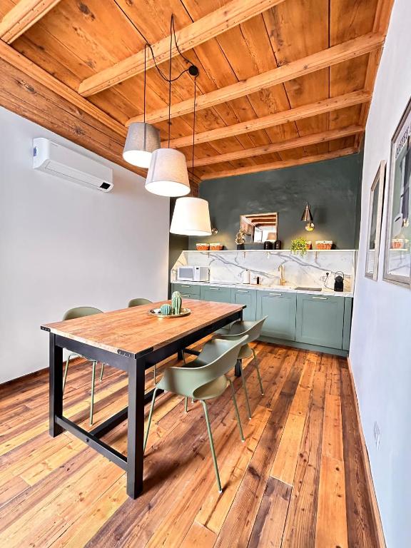 a dining room with a wooden table and chairs at La Loggia dei Mercanti in Cuneo