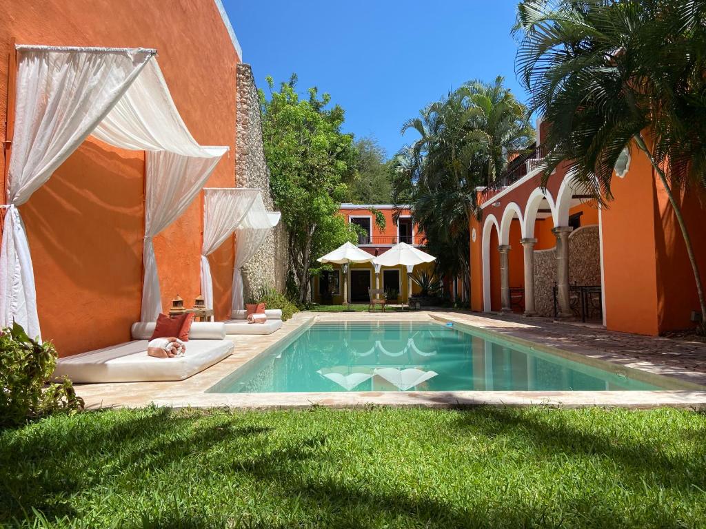 a swimming pool in the yard of a house at Art 64 Hotel Boutique - Adults Only in Mérida