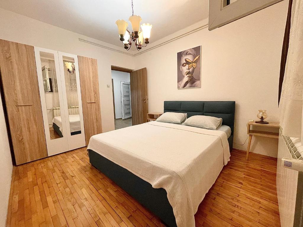 a bedroom with a large bed in a room at Apartment Milos in Belgrade