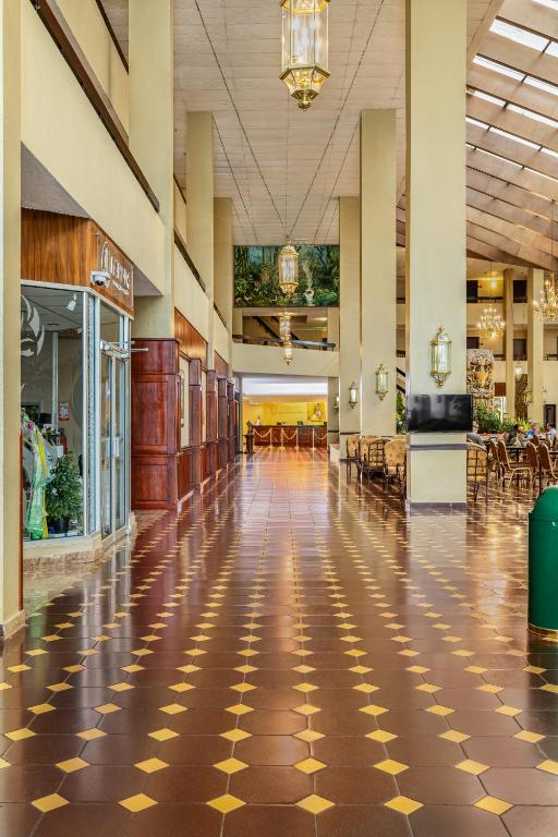 a lobby with a checkered floor in a mall at Copantl Hotel & Convention Center in San Pedro Sula