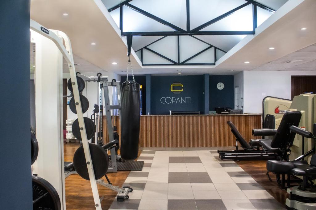 a gym with dumbbells and weights in a gym at Copantl Hotel & Convention Center in San Pedro Sula