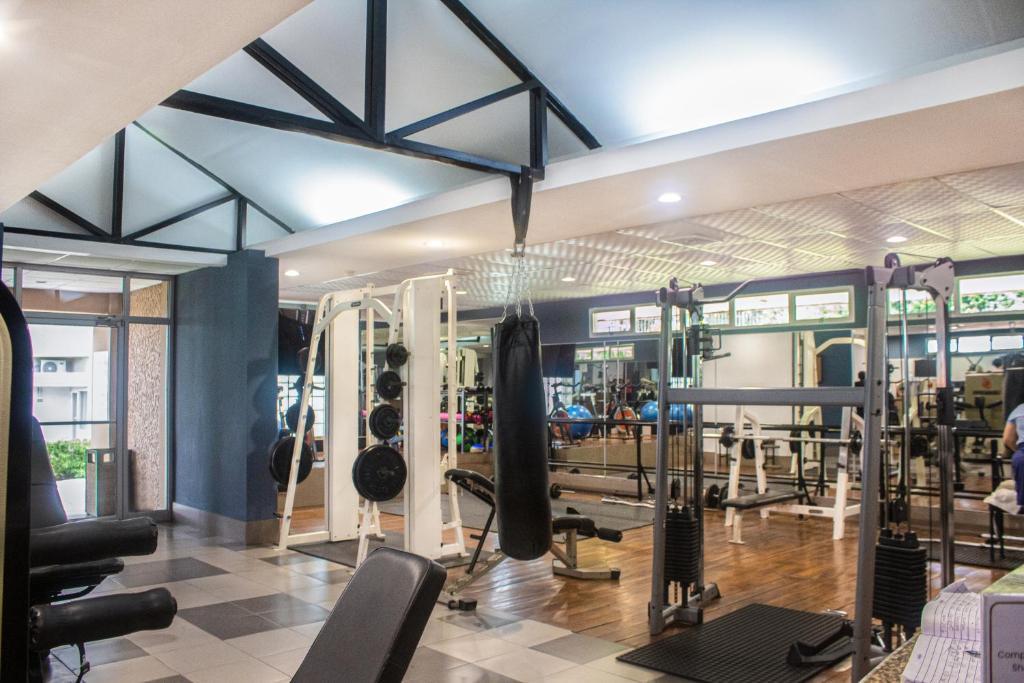 a gym with treadmills and machines in a room at Copantl Hotel & Convention Center in San Pedro Sula