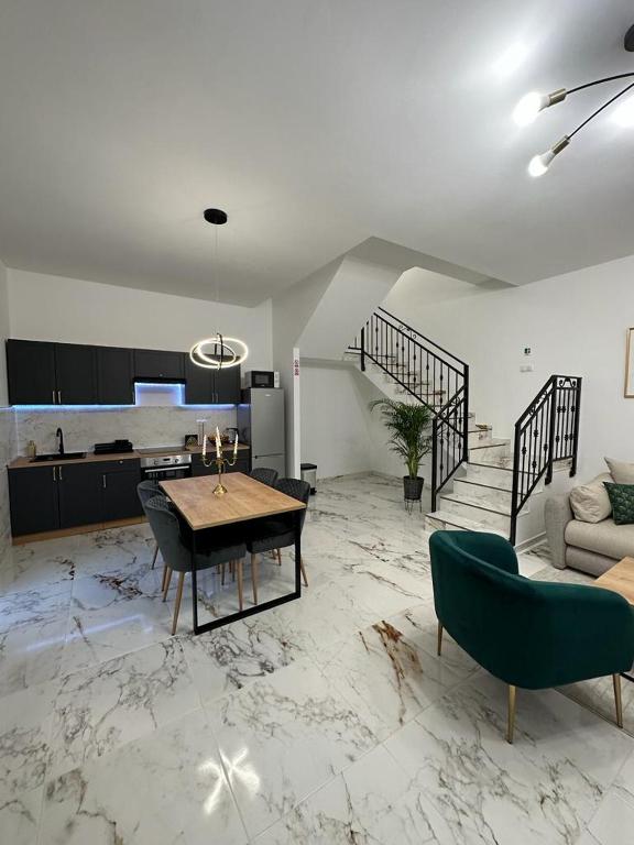 a living room with a table and a couch at Apartments Green Linden in Lipovača