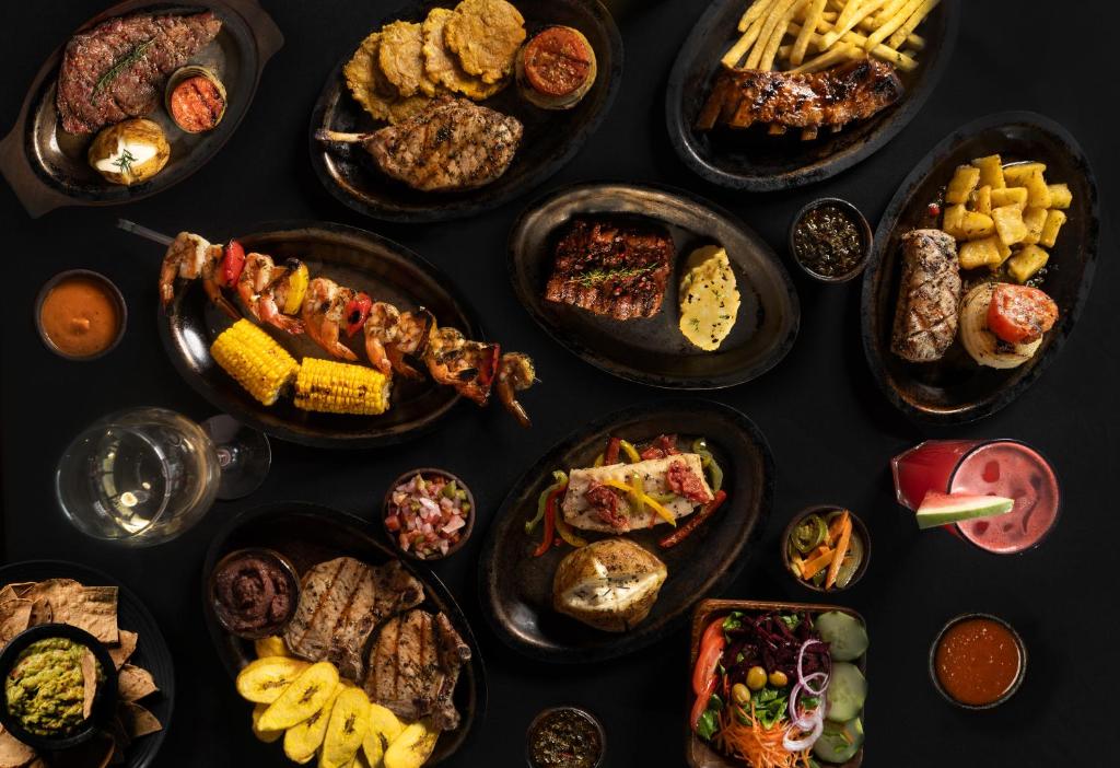 a table full of different types of food on plates at Copantl Hotel & Convention Center in San Pedro Sula
