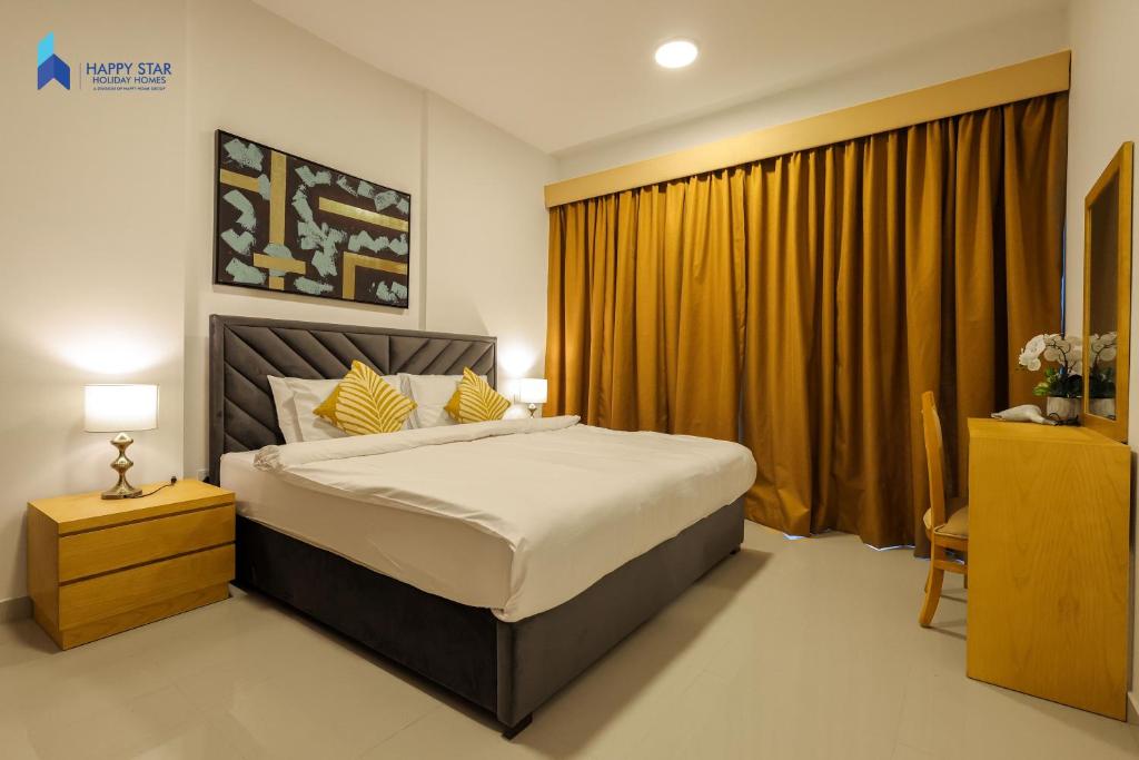 a bedroom with a large bed and a yellow curtain at 2 BR Perfect for Family/Groups near MOE in Dubai