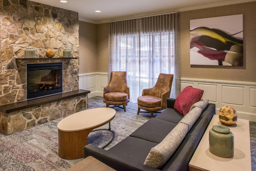 a living room with a couch and a fireplace at Courtyard Clemson in Clemson