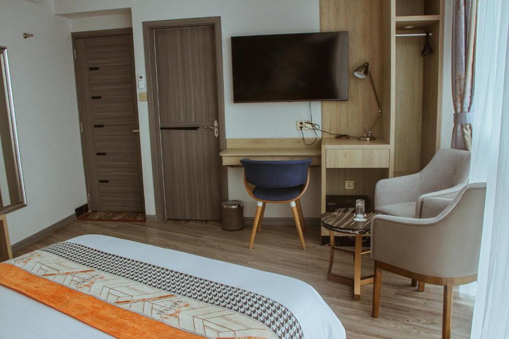 Ένα ή περισσότερα κρεβάτια σε δωμάτιο στο Gold Source Hotel