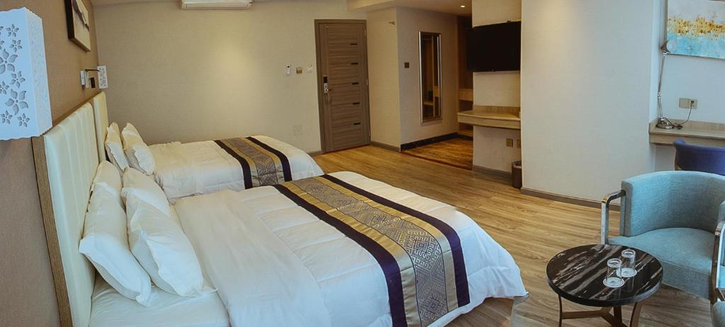 Ένα ή περισσότερα κρεβάτια σε δωμάτιο στο Gold Source Hotel