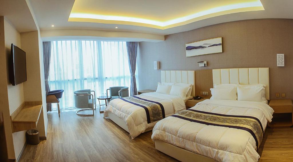 Ένα ή περισσότερα κρεβάτια σε δωμάτιο στο Gold Source Hotel