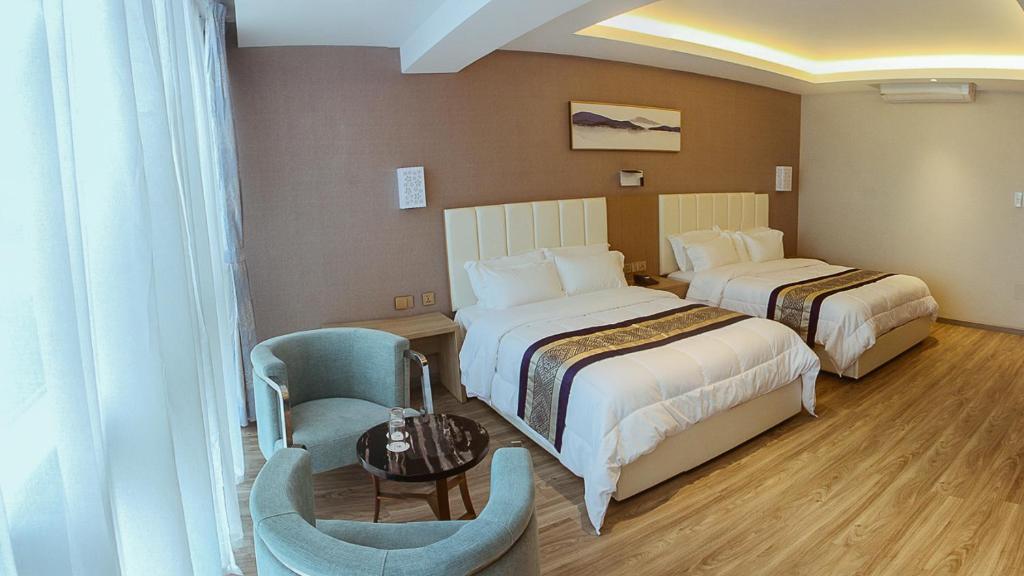 Ένα ή περισσότερα κρεβάτια σε δωμάτιο στο Gold Source Hotel
