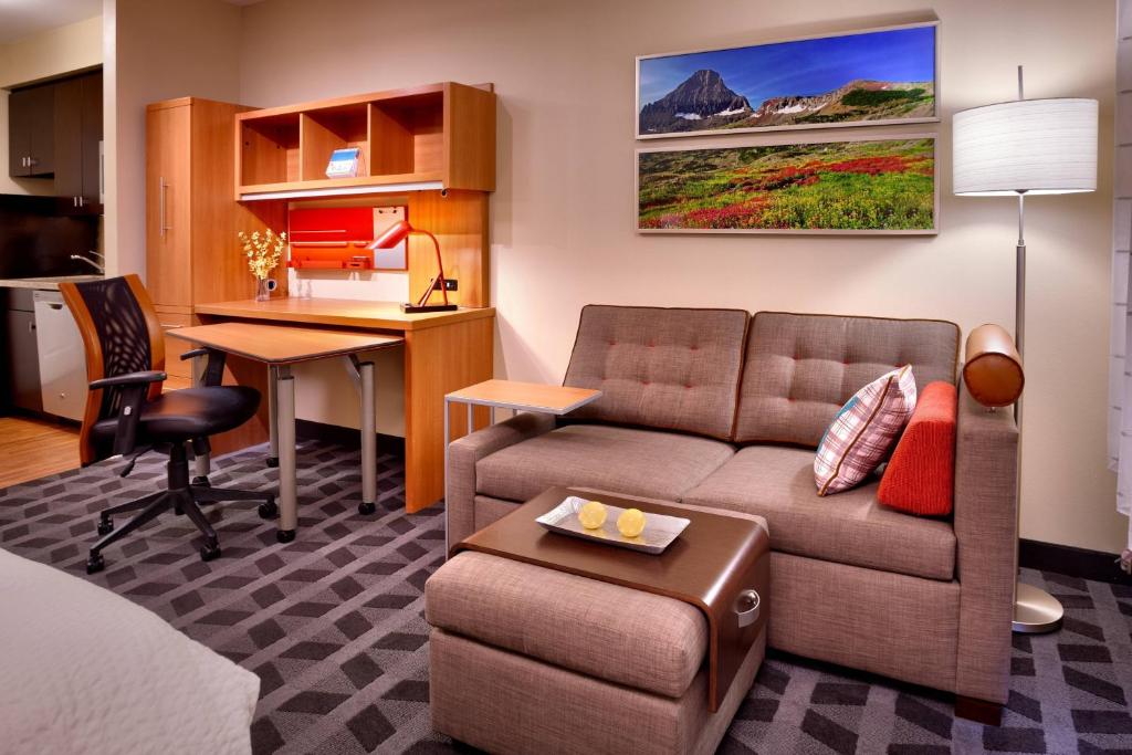 a living room with a couch and a desk at TownePlace Suites by Marriott Missoula in Missoula