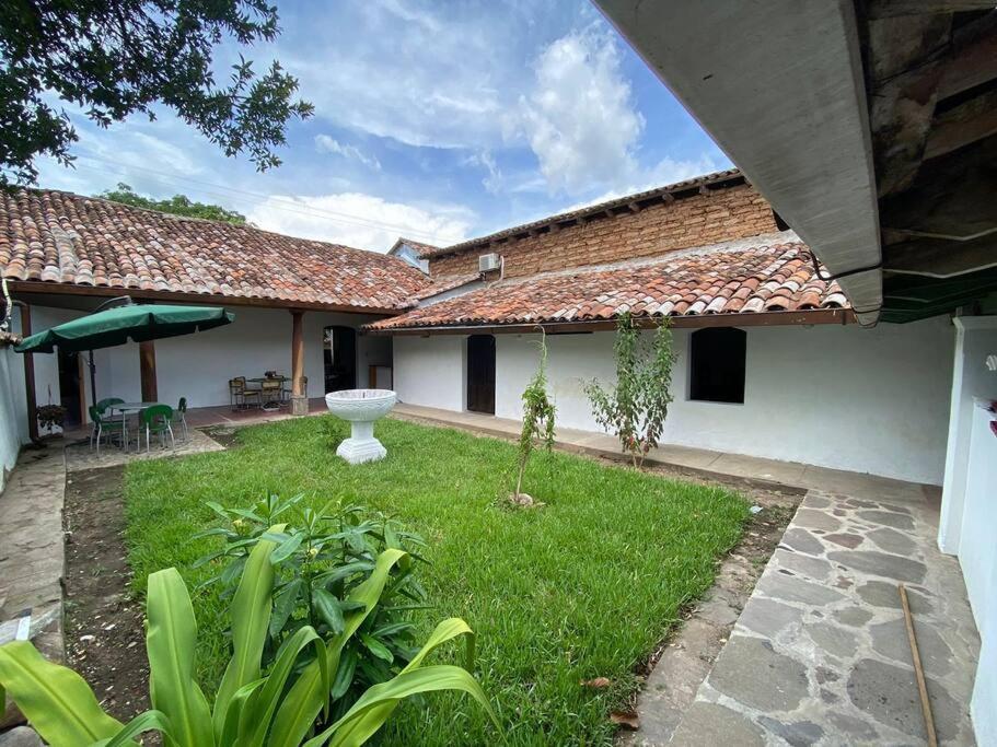 a courtyard of a house with a green yard at Casa Colonial in Suchitoto