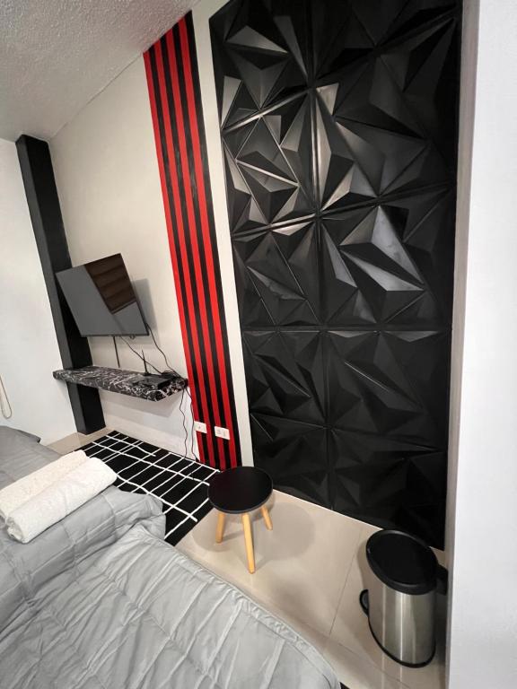 a bedroom with a bed and a black wall at *Top Choice Awardee B 2023 in Iloilo City