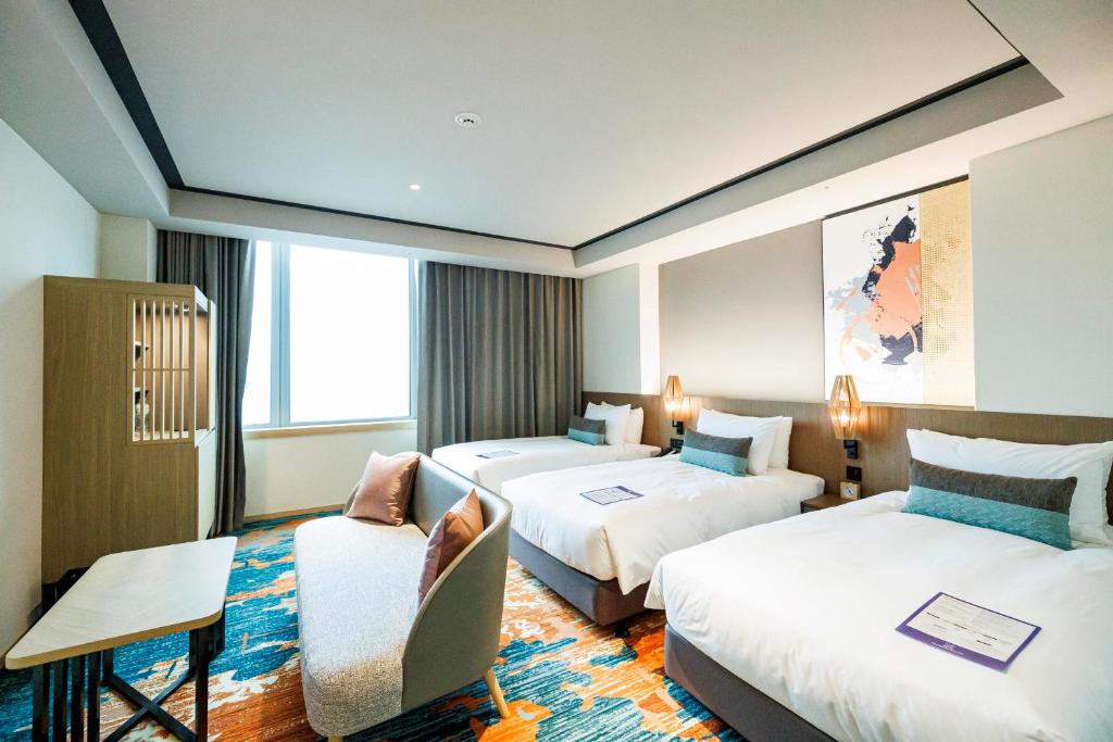 Postel nebo postele na pokoji v ubytování Solaria Nishitetsu Hotel Taipei Ximen