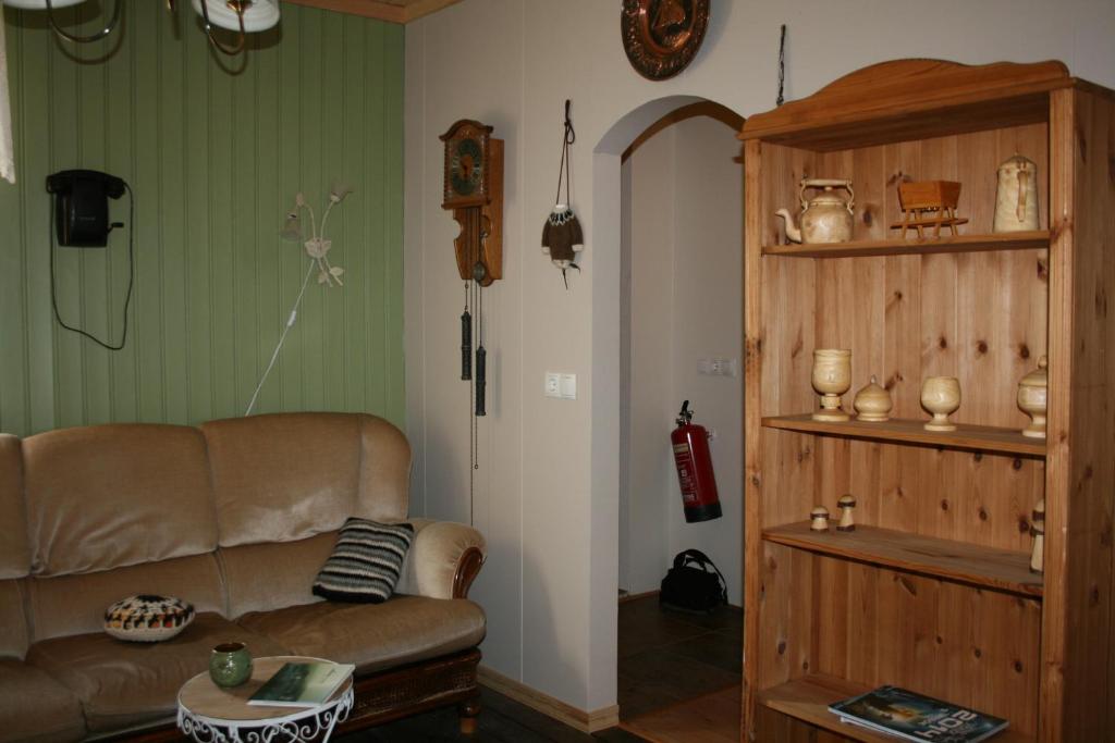 a living room with a couch and a table at Litlabjarg Guesthouse in Hrafnabjorg