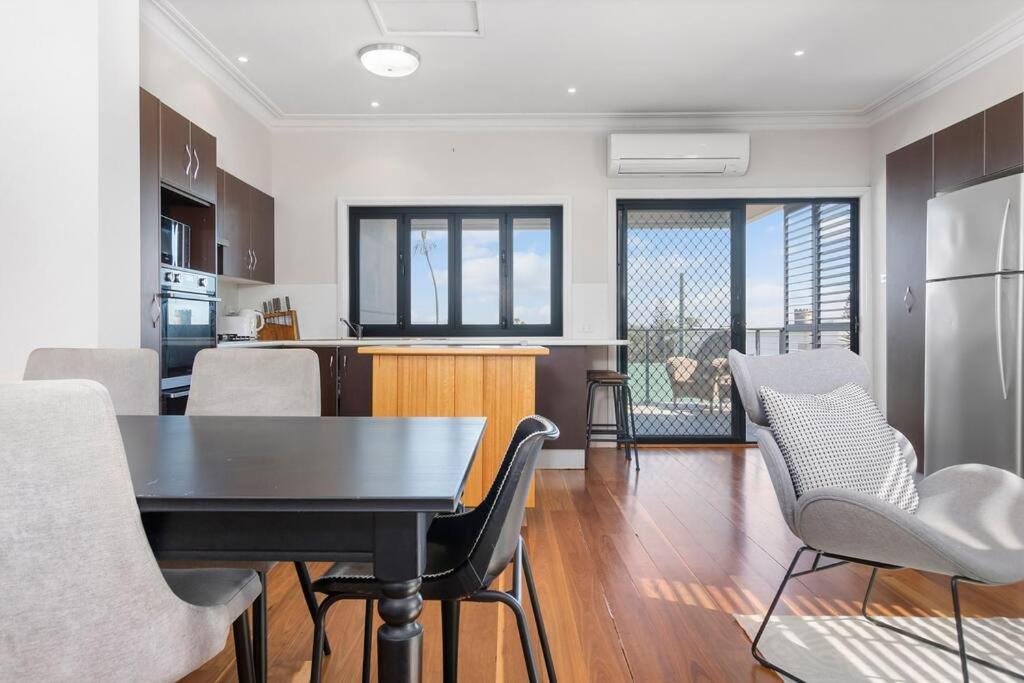 a kitchen and dining room with a table and chairs at Classic Elegance on The Hill in Newcastle