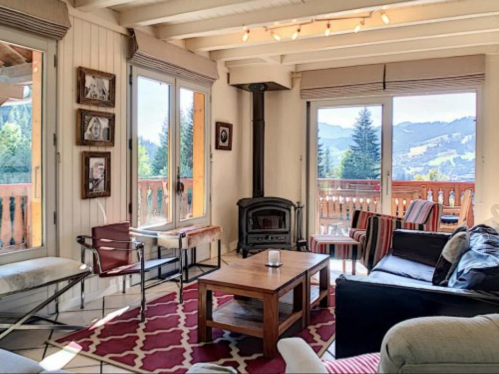 a living room with a couch and a table at Chalet Les Gets, 8 pièces, 12 personnes - FR-1-671-141 in Les Gets