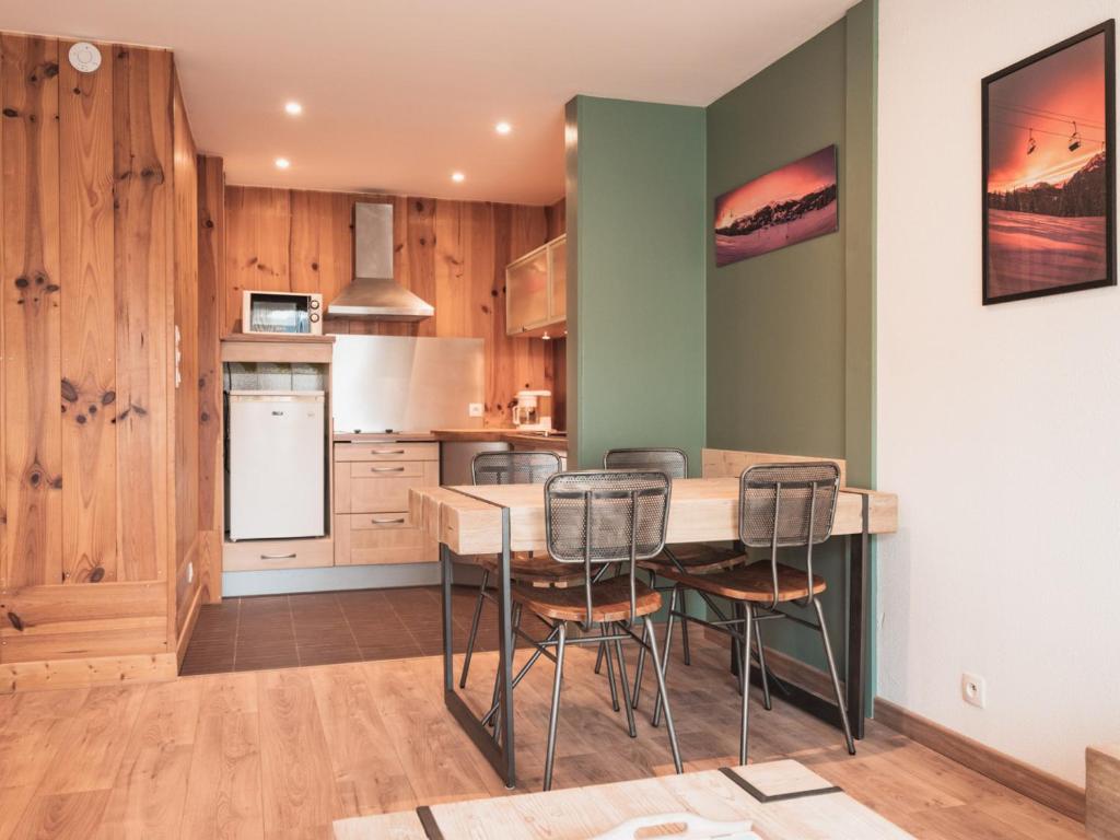 a kitchen with a table and chairs in a room at Appartement Les Gets, 2 pièces, 3 personnes - FR-1-671-120 in Les Gets