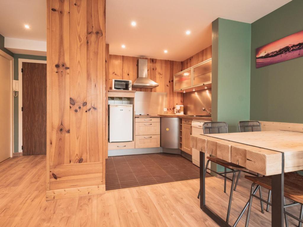 a kitchen with wooden walls and a table with chairs at Appartement Les Gets, 2 pièces, 3 personnes - FR-1-671-120 in Les Gets
