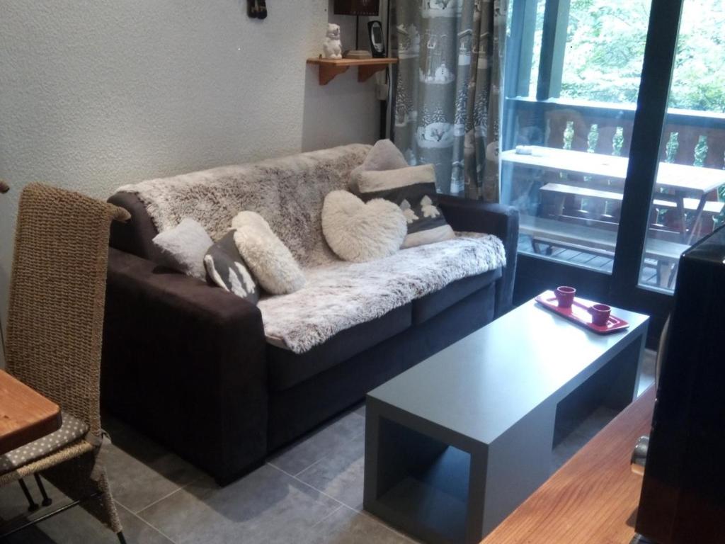 ein Wohnzimmer mit einem Sofa und einem Couchtisch in der Unterkunft Appartement Les Gets, 2 pièces, 4 personnes - FR-1-671-103 in Les Gets