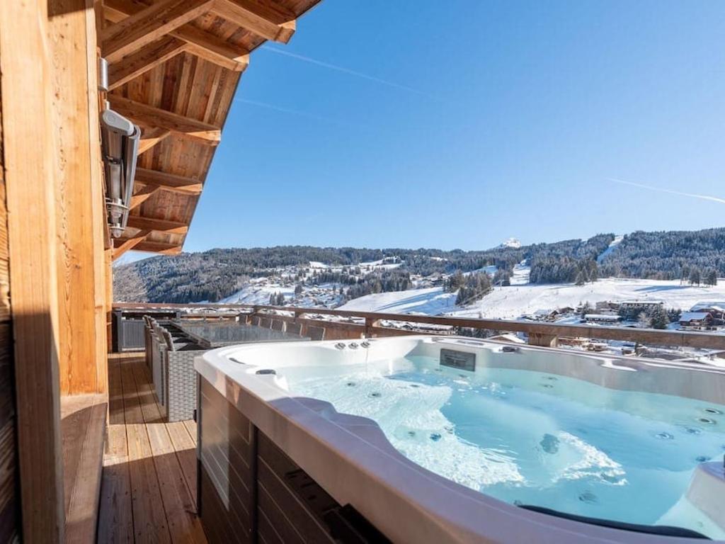 a hot tub on the balcony of a house at Chalet Les Gets, 7 pièces, 12 personnes - FR-1-671-138 in Les Gets